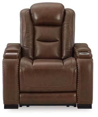 Reserved for him and made for her, this mahogany hued power recliner delivers all the comfort and style you could ask for. Inspired by sports car interiors, the Man-Den power recliner features real leather in the seating area for your pleasure. The advanced one-touch power control puts you in the driver’s seat with an adjustable headrest and lumbar support, USB port and wireless charging for your phone, plus an integrated cup holder, all at your fingertips. This power recliner utilizes every inch of space, with hidden storage compartments under the padded armrests.One-touch power control with Easy View™ power adjustable headrest, power lumbar support, USB charging and wireless phone charging | Wireless charger accommodates later model smartphones, including Apple iPhone, Samsung Galaxy, Huawei Mate and Nokia Lumia | Corner-blocked frame with metal reinforced seat | Attached cushions | High-resiliency foam cushions wrapped in thick poly fiber | Leather interior upholstery (with perforated details); vinyl/polyester (faux leather) exterior upholstery | Armrest with storage compartment | 2 cup holders | 43" high back | Extended ottoman for enhanced comfort | Nailhead trim | Power cord included; UL Listed | Estimated Assembly Time: 15 Minutes